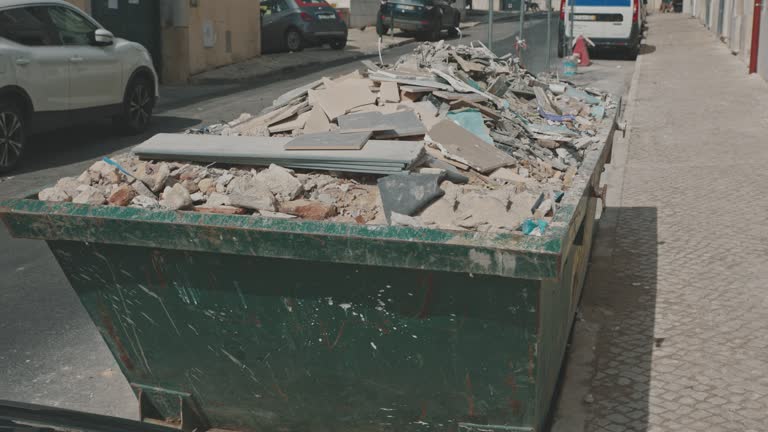 construction waste in a container on the street. mid shot