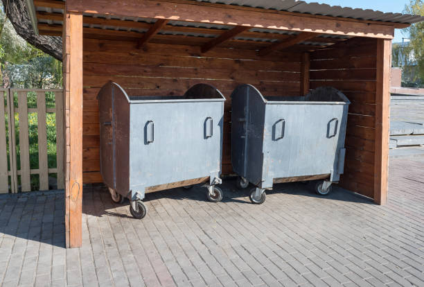 metal garbage container in a wooden gazebo on the street