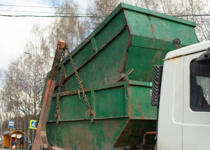 transportation of container. garbage truck. steel container on transporter.